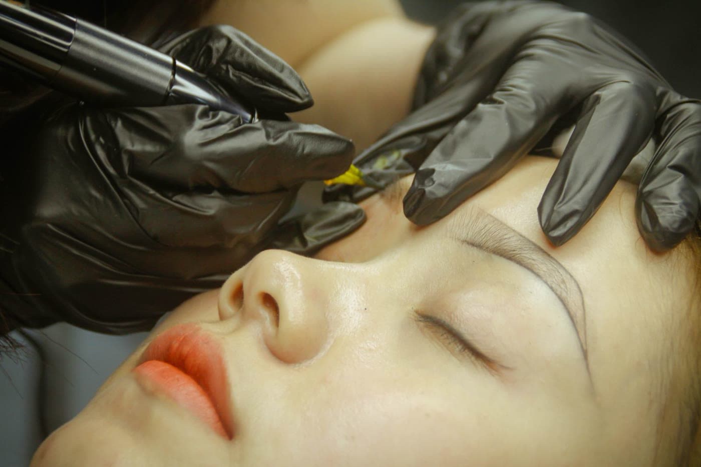 A powder brow permanent makeup procedure in progress
