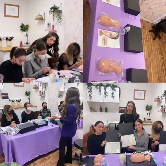 A small group lash class with training stations, mannequin heads, and graduates holding certificates